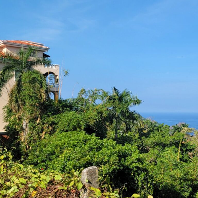 image of beige spanish style villa overlooking the ocean in the tropics