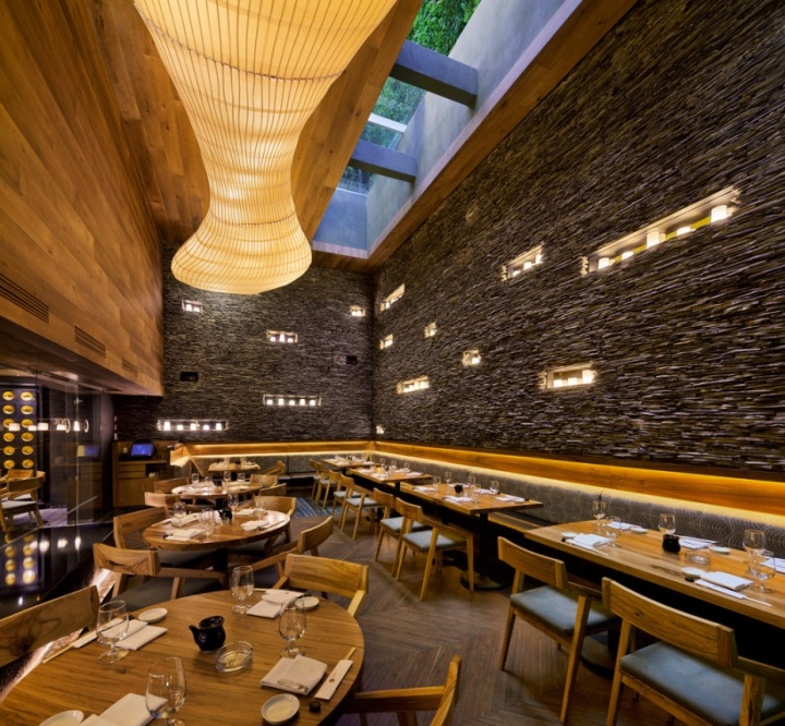 interior of modern restaurant that has ambient lighting, clean lines and light wood furniture