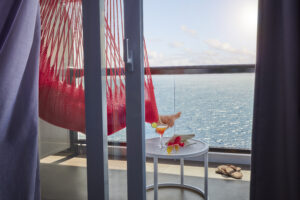 Legs in a hammock on a terrace onboard Scarlet Lady.