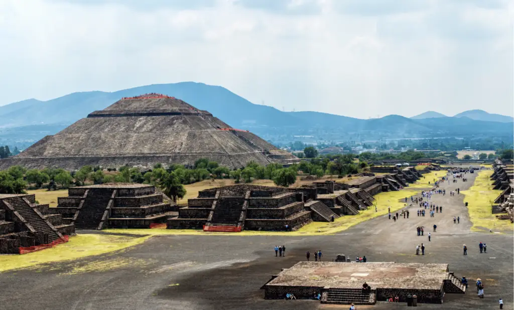 ancient ruins against a backdrop of mountains